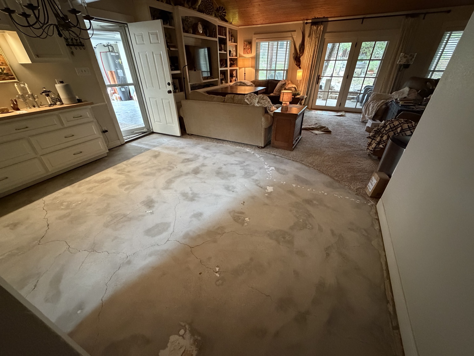 Exposed concrete slab near the living area after Dust Kingz tile removal in Joshua, Texas.